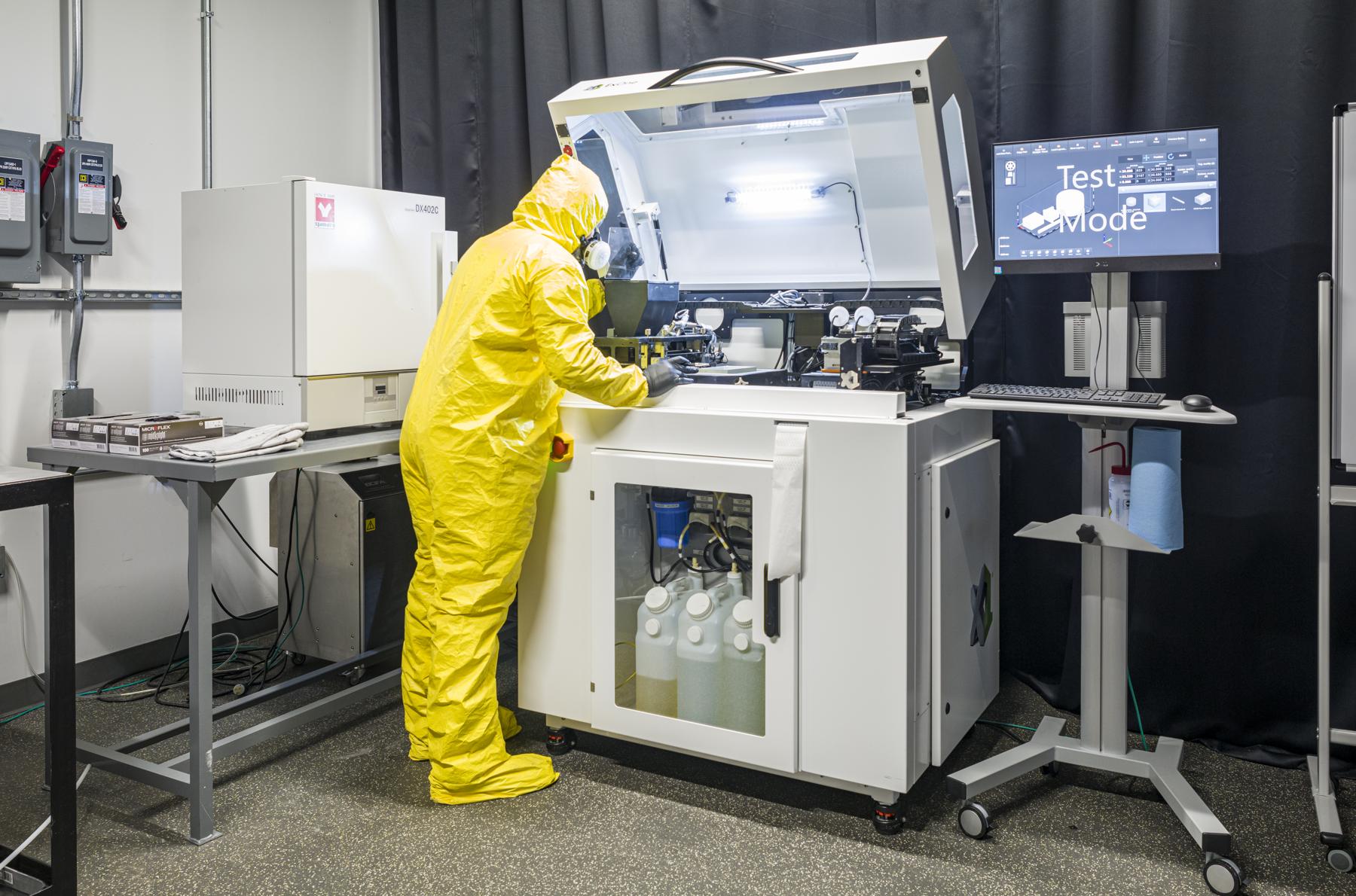 Person in a yellow lab suit using the ExOne Innovent+